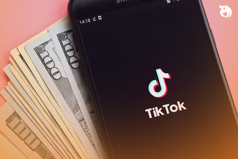 Tiktok,application,on,samsung,smartphone,screen,and,dollar,bills.,tiktok